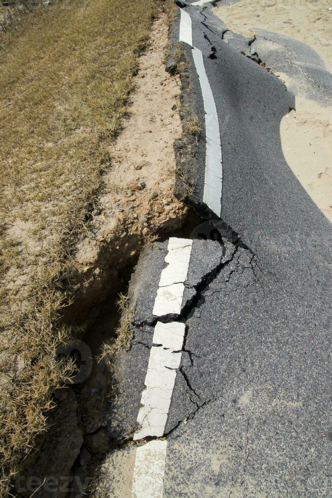 Road erosion caused by waves and severe storms. photo