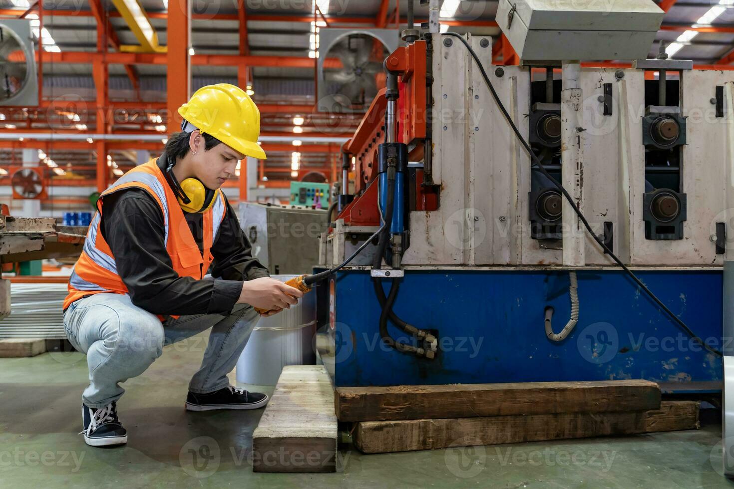 Engineering technician worker is operating the machine inside factory using touch screen computer monitor to command the order for line production and steel industry photo