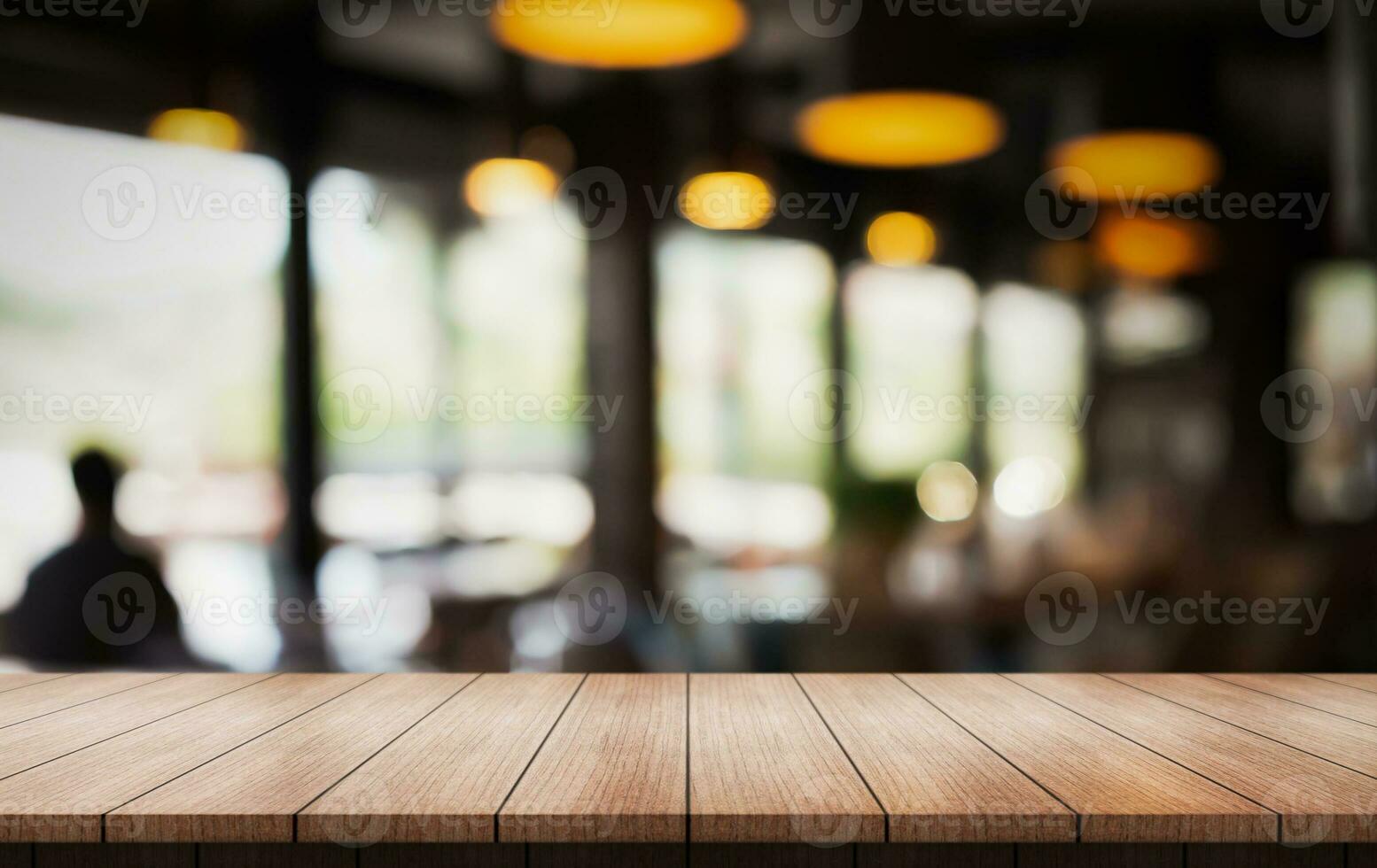Empty wooden table top with lights bokeh on blur restaurant background. photo