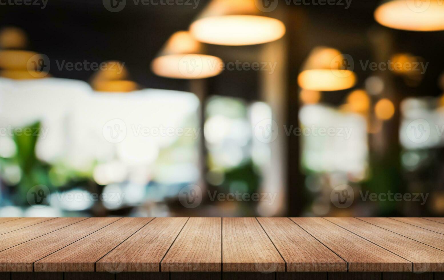 Empty wooden table top with lights bokeh on blur restaurant background. photo
