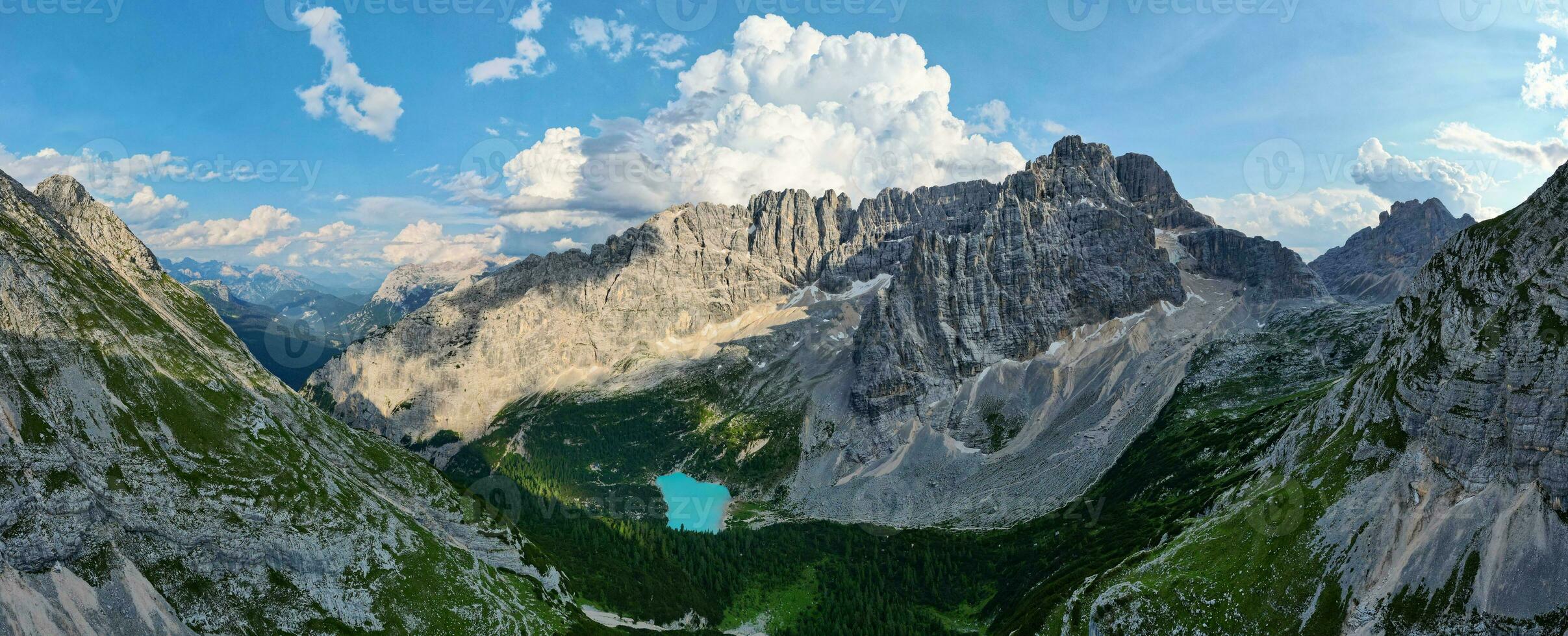 Panorama view of the blue turquoise Lake Sorapis, Lago di Sorapiss, with mountains with the background in Dolomites. One of the most beautiful lakes in Italy. Famous destination. photo