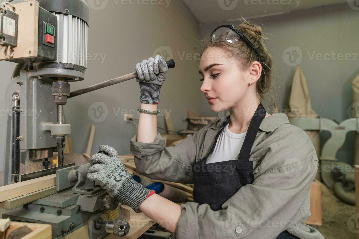 A young female carpenter working Project in her workshop. Female carpenter making wooden furniture. photo