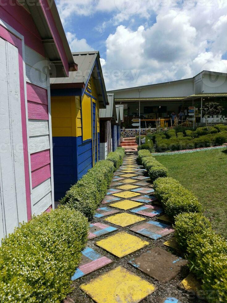 Colorful wooden houses in a row in a public park. Colorful beach huts. photo