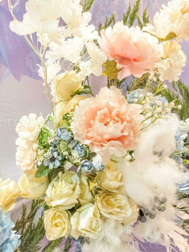 Colorful of artificial flowers on the wall for decorate in wedding ceremony photo