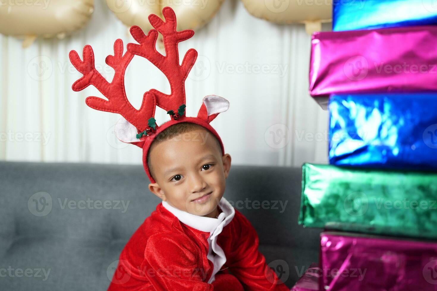 Merry Christmas 2024 concept Boy receives a gift from his mother at christmas photo