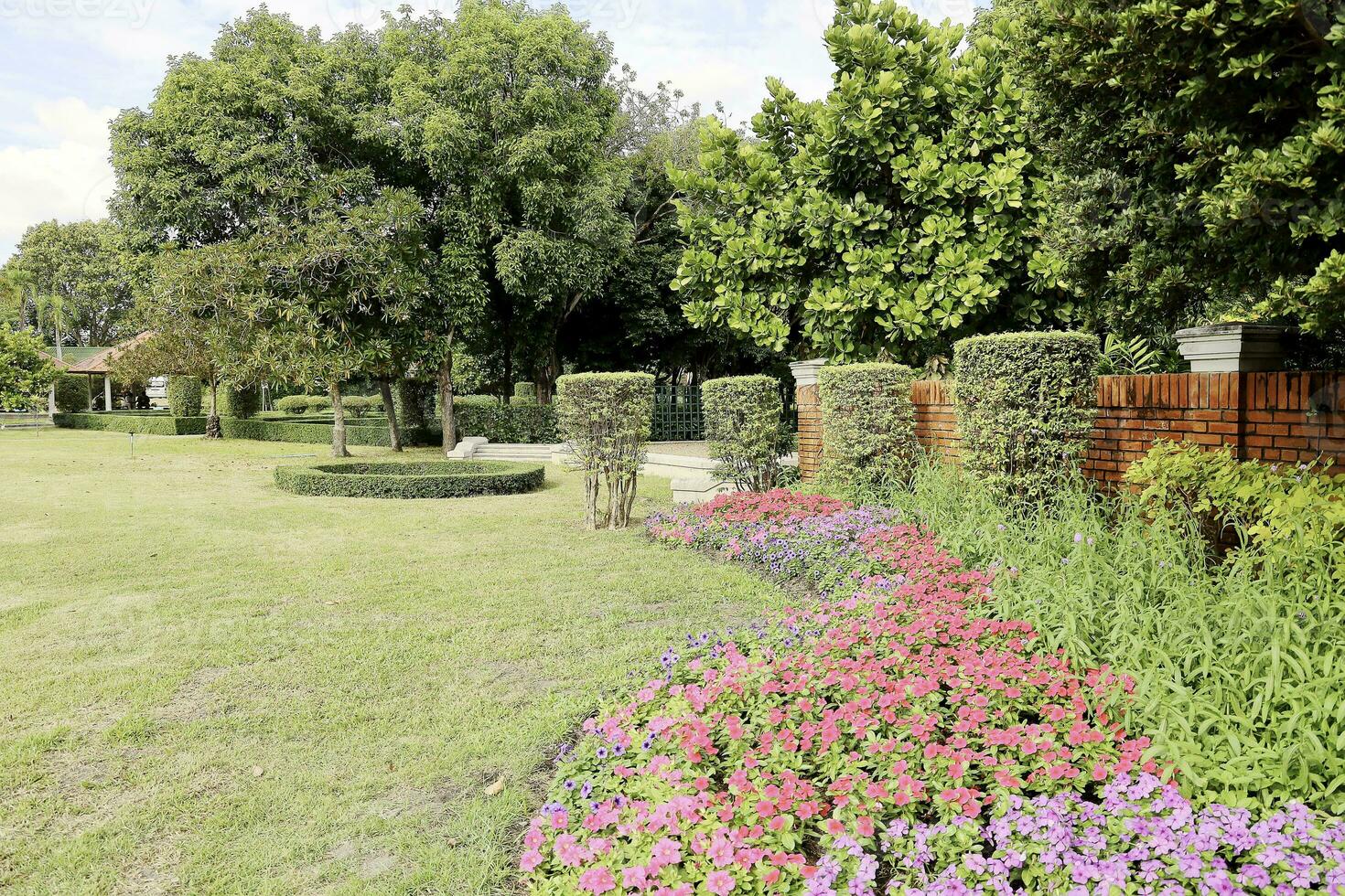 Scenic View of a Beautiful Flower Style Landscape Garden with a Green Mowed Lawn and Colourful Flower Bed with Selective Focus photo