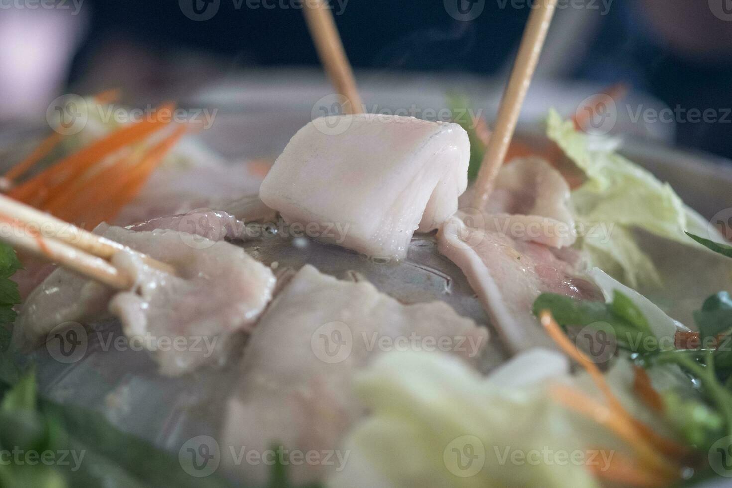 Pork on a hot plate, you can grill many things, One bit piece of raw pork lard on the center of pan photo