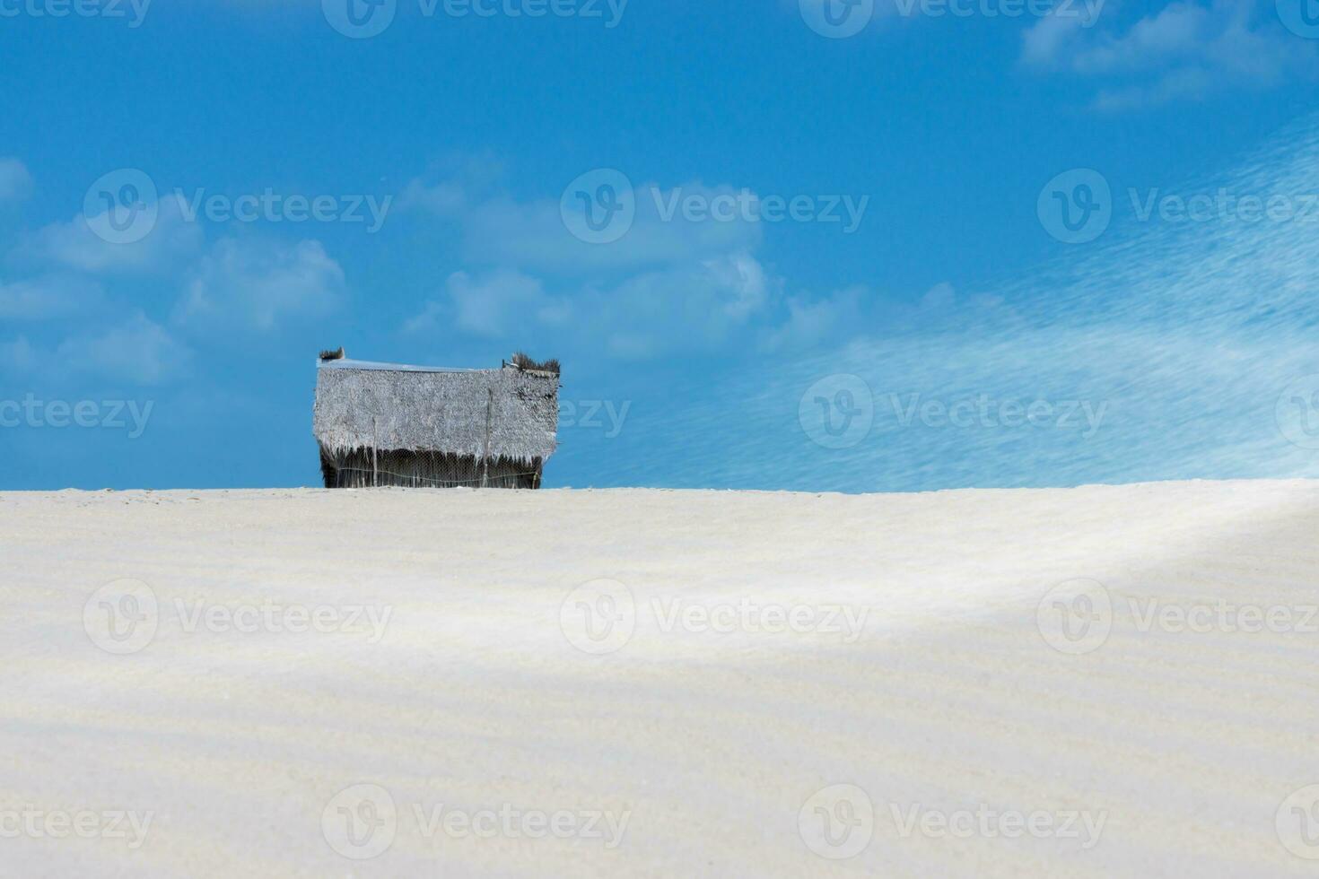 Fisherman's hut on the beach with sand and sky. photo
