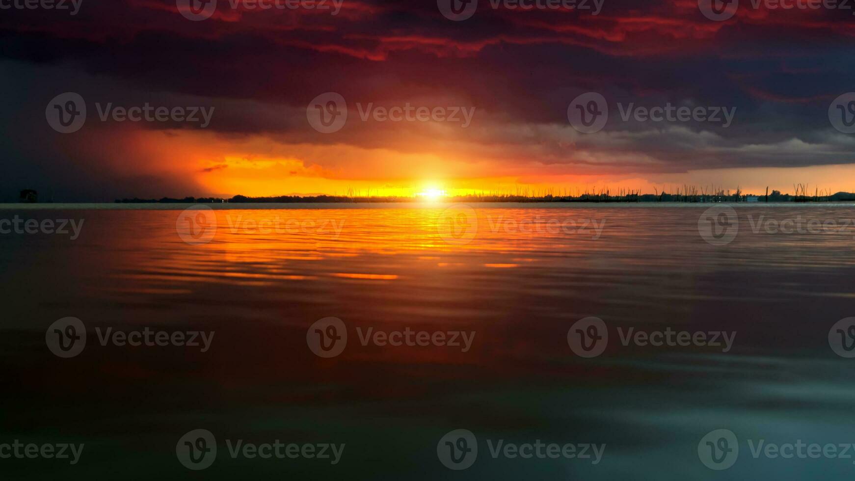 Sunset sky at the lake under the red cloud. photo