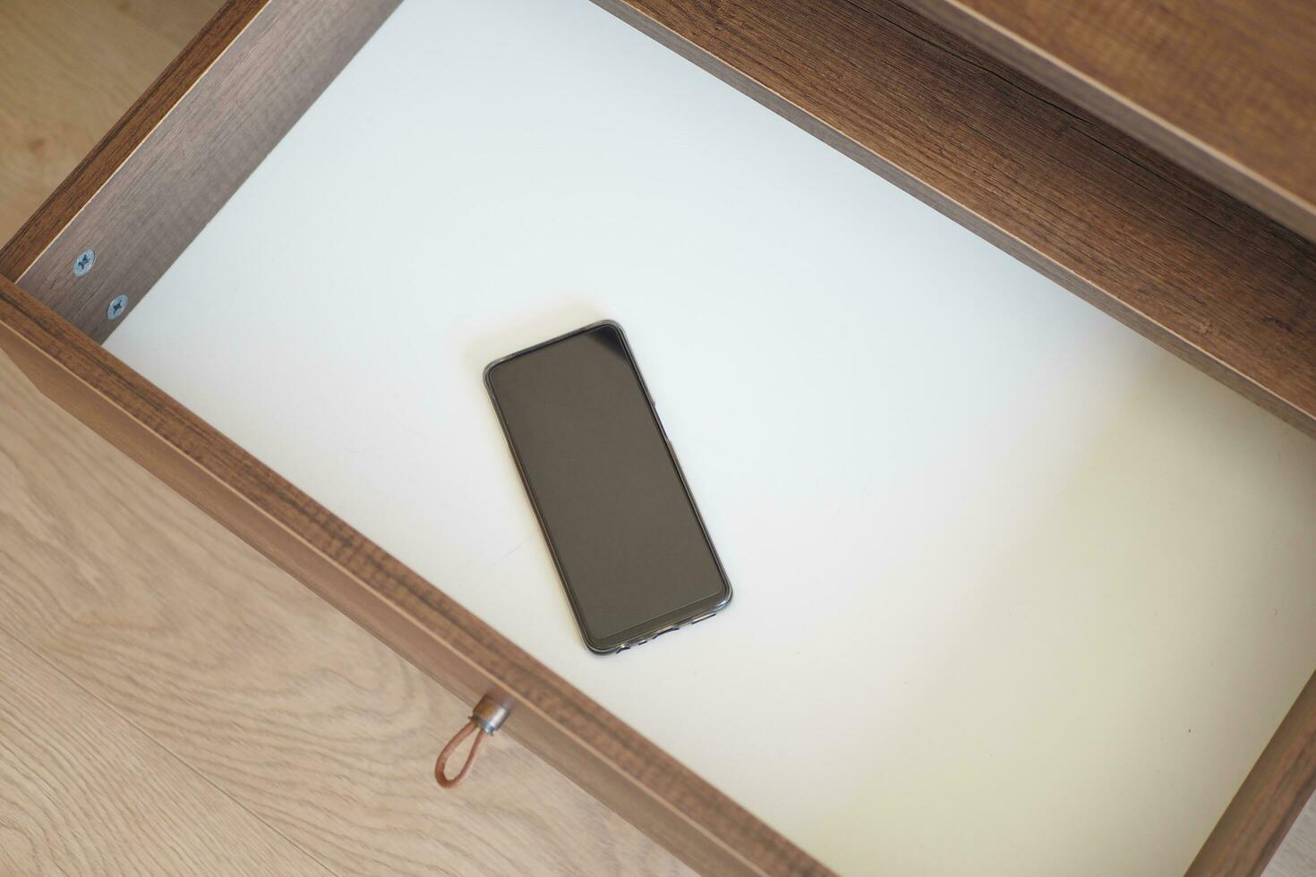 mobile phone in open drawer. photo