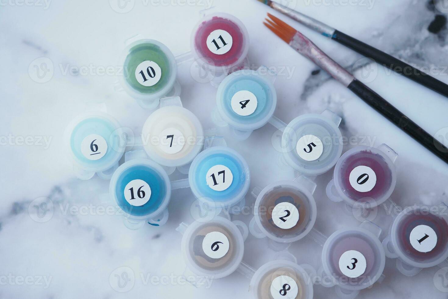 Paints and paint brushes in an artists studio. photo