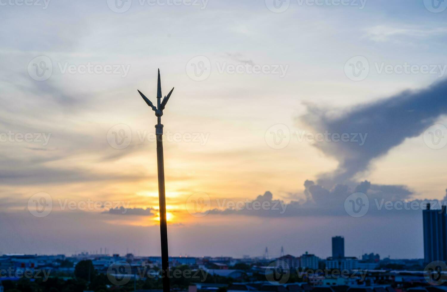 Lightning rod on the rooftop of condominium in evening time photo