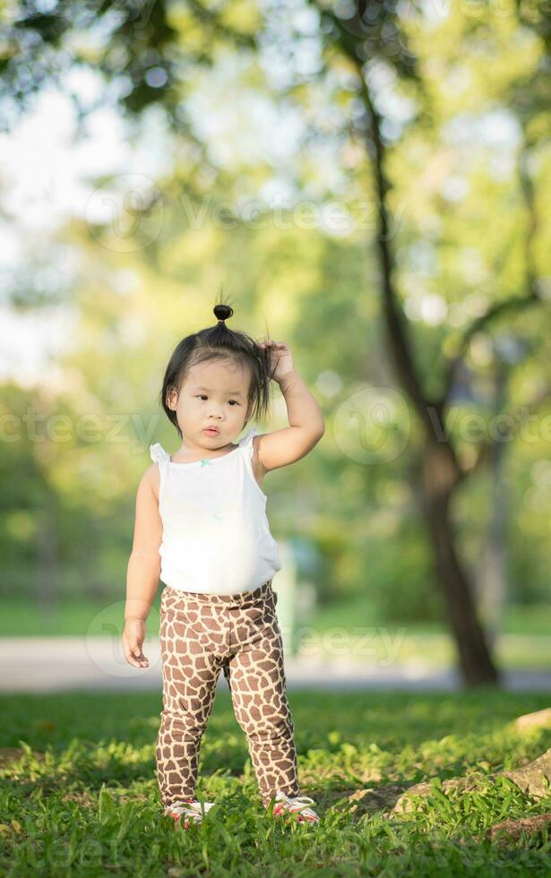 Portrait of little girl  walking in the park photo