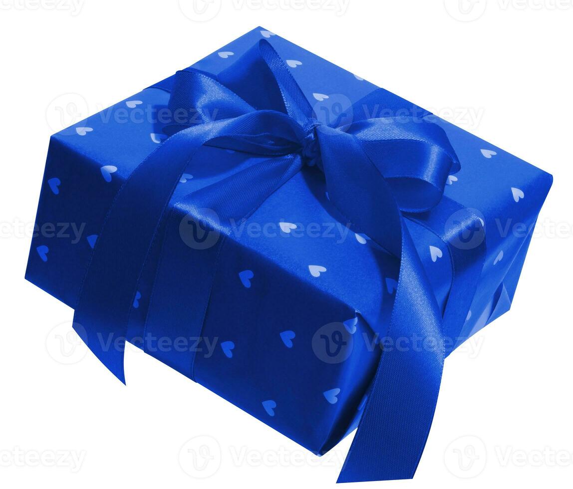 Box is wrapped in blue gift wrapping and blue ribbon on a white isolated background photo