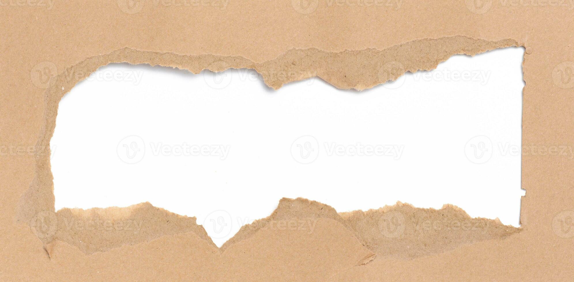 Torn edges of brown paper on a white background, space for writing photo