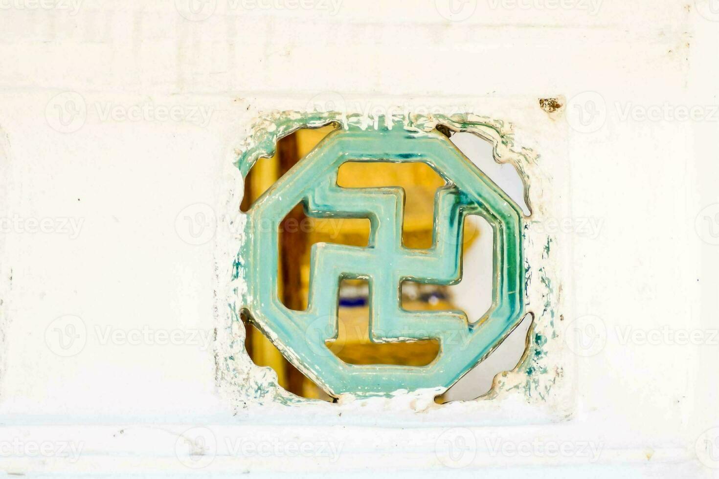 a swastika symbol on a white wall photo