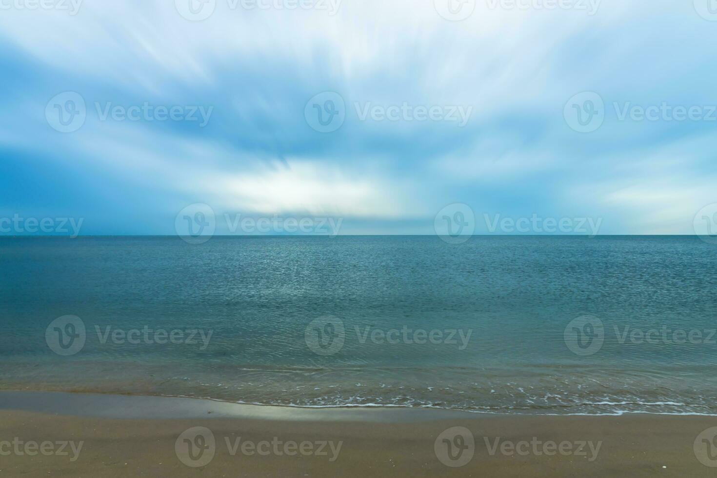 Quiet blue sea with motion cloud. photo