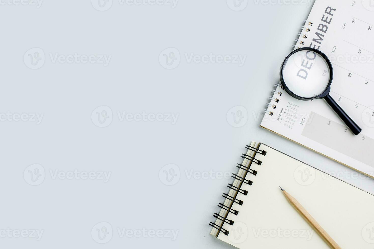 Top view of December calendar page, last month of the year on white table. concept of designing reports, analyses, and profit summaries for the last month of the year. photo