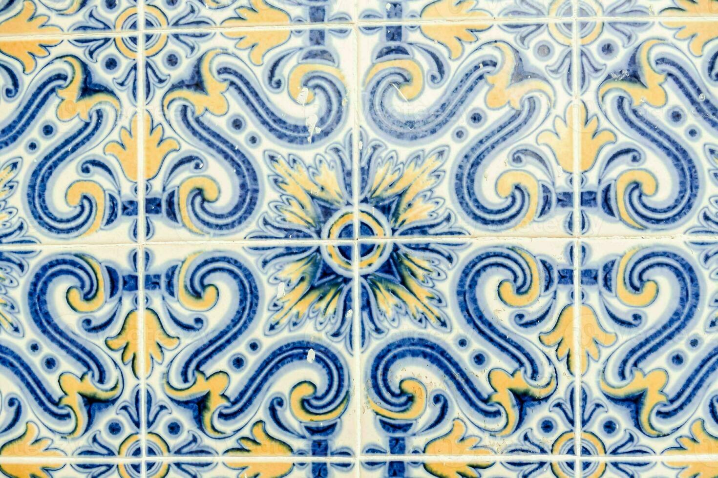 a blue and yellow tile with a design on it photo