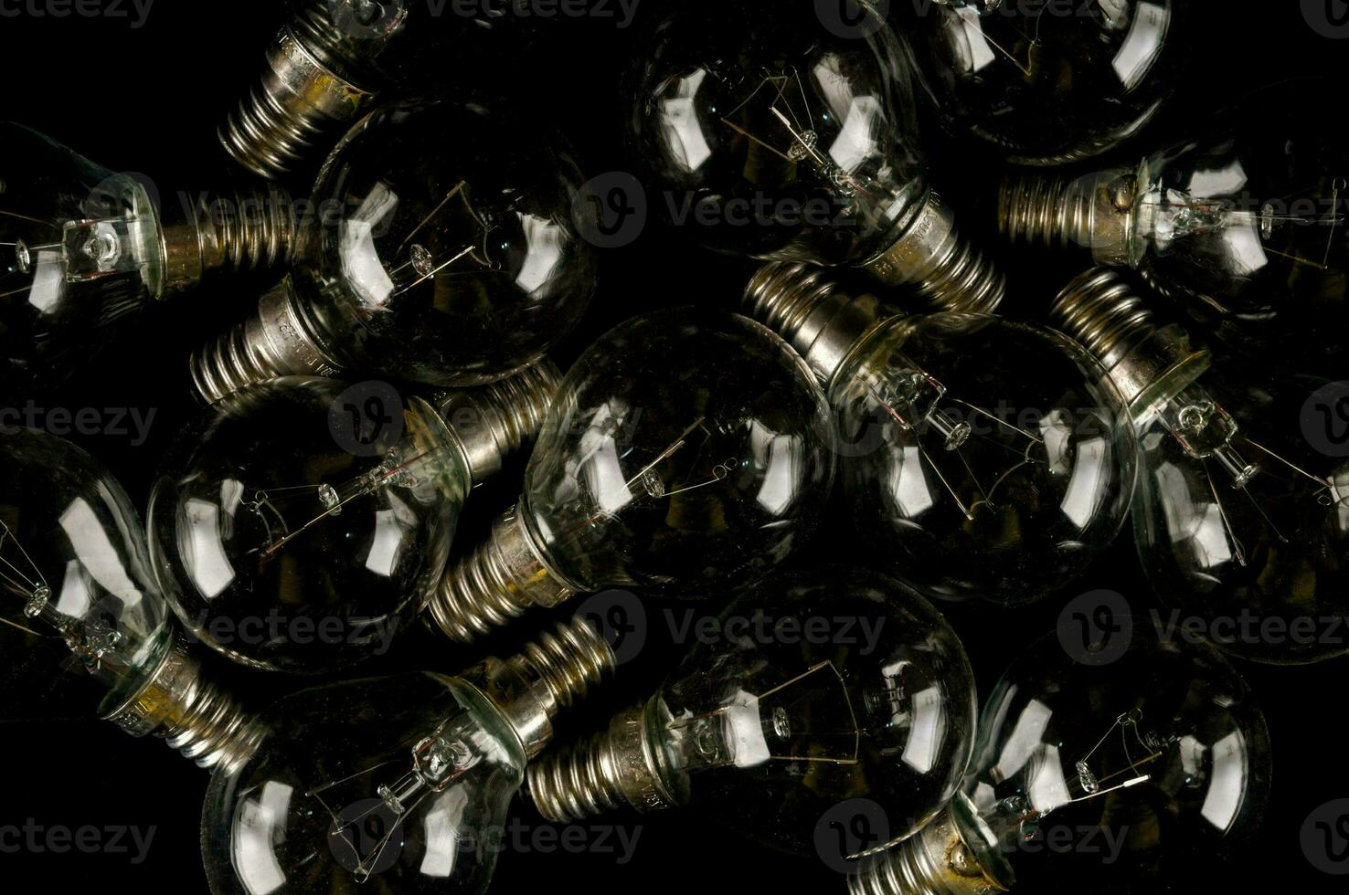 a pile of light bulbs on a black background photo