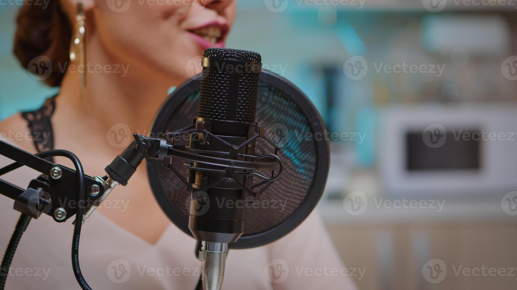 Close up of social media star talking in the microphone. Creative online show presenter, Onair online production internet broadcast show host streaming live content, recording digital social media photo