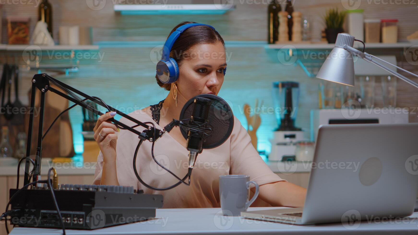 Video blogger typing on laptop and recording voice for podcast using professional microphone. Creative online show Onair production internet broadcast show host streaming live content, recording digital social media communication photo