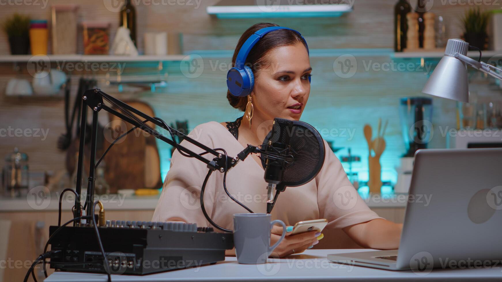 Famous influencer reading messages from fans on her phone during live on her social media. Creative online show Onair production internet broadcast host streaming live content, recording digital social media communication photo