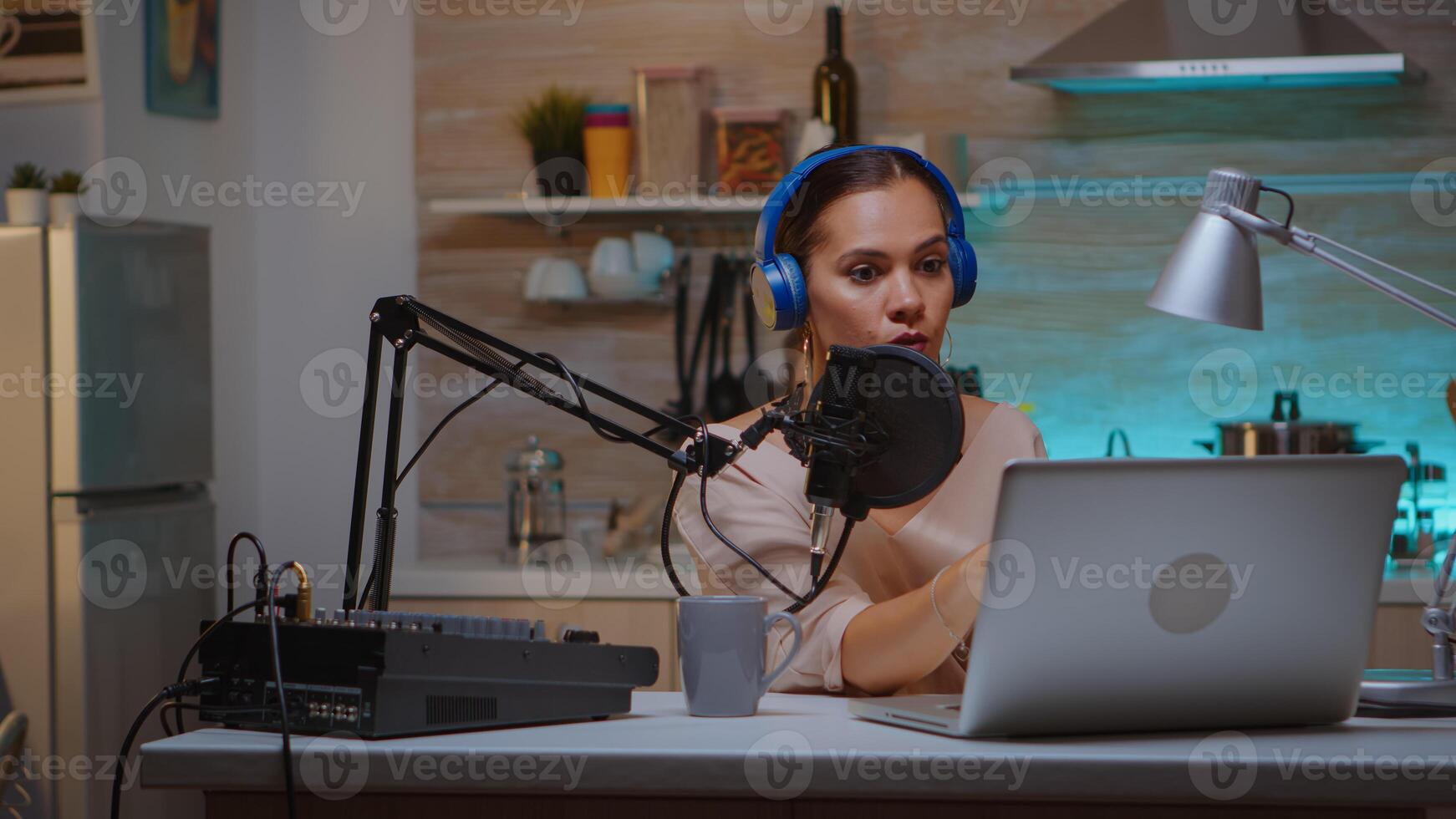 Video blogger reading email and wearing headphones during broadcast. Creative online show Onair production internet broadcast host streaming live content, recording digital social media communication photo