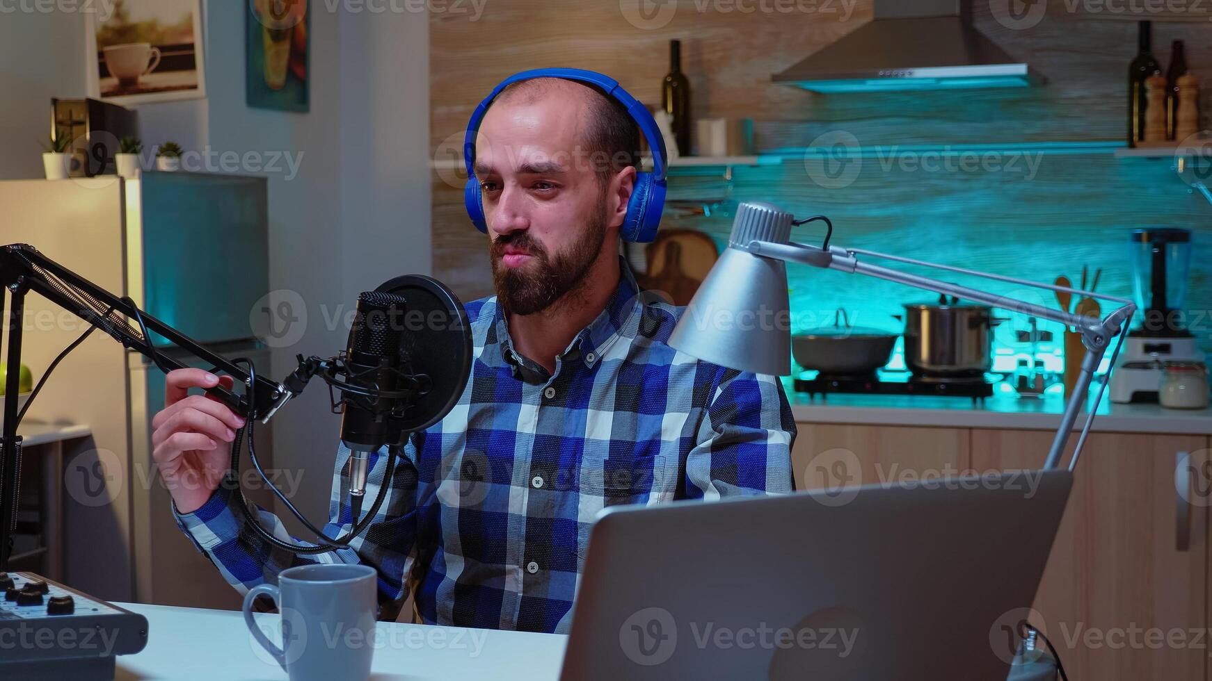 Man speaking during his online show into professional microphone. Creative online show Onair production internet broadcast host streaming live content, recording digital social media communication photo