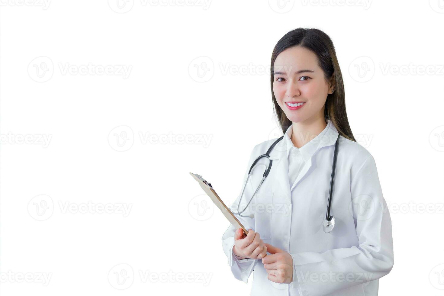 Professional beautiful young woman doctor holding document in clipboard smiling while she wears white lab coat and stethoscope in hospital while isolated on white background. Health concept. photo