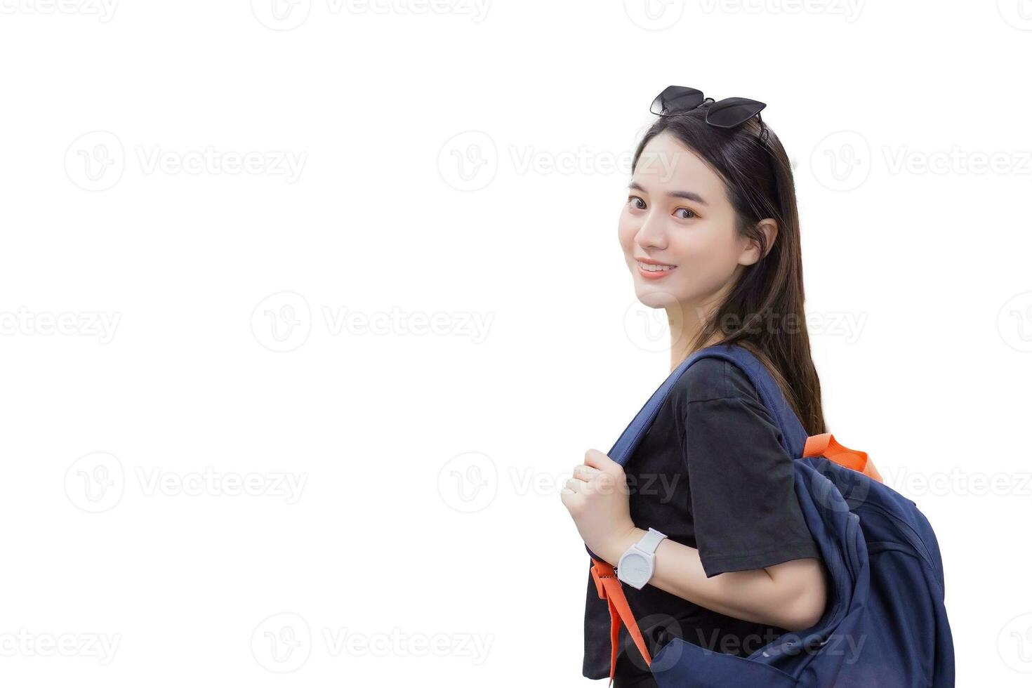 Young Asian beautiful woman tourist, wearing  black T  shirt, smiled into carried backpack while isolated on white background. photo