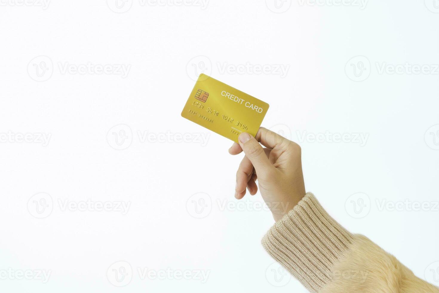 Woman's right hand holds a golden credit card, isolated on a white background. Concept of technology, connection, communication, social, online shopping. photo