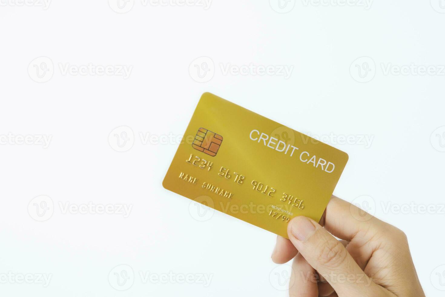 Woman's right hand holds a golden credit card, isolated on a white background. Concept of technology, connection, communication, social, online shopping. photo