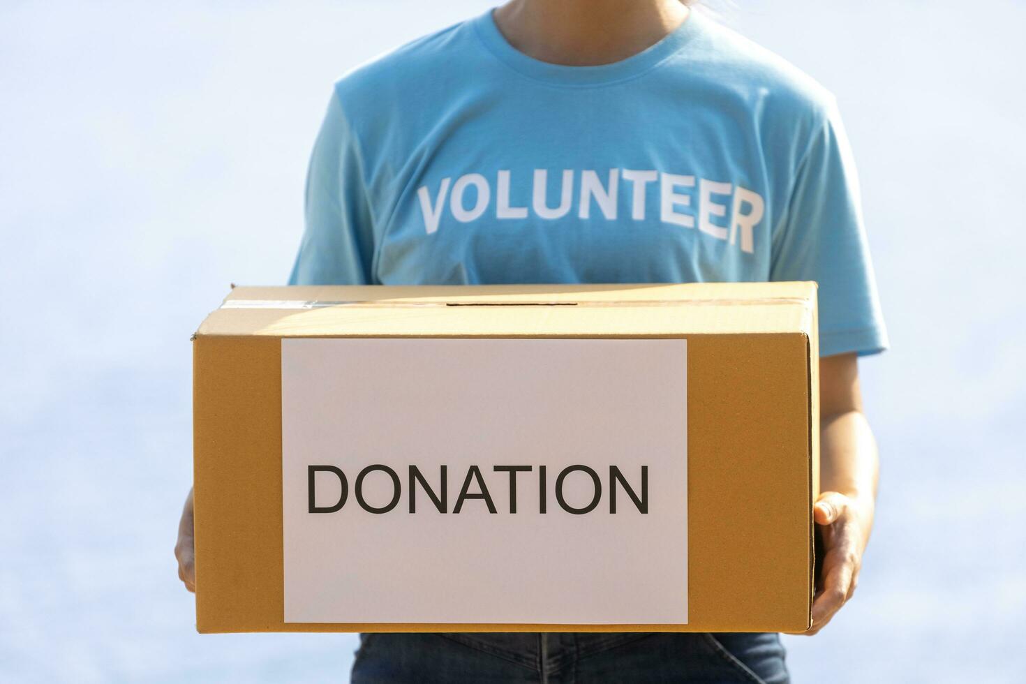 Volunteer people is holding box of money raising donation in the charity work and ngo related activity such as global warming, environmental issues, pollution and eco-friendly project photo