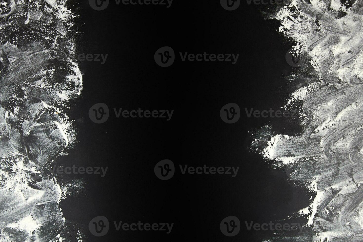Abstract background. The flour is scattered on a black background. Copy space. photo