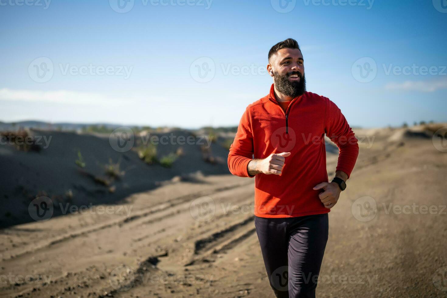 Adult man is jogging outdoor on sunny day. photo