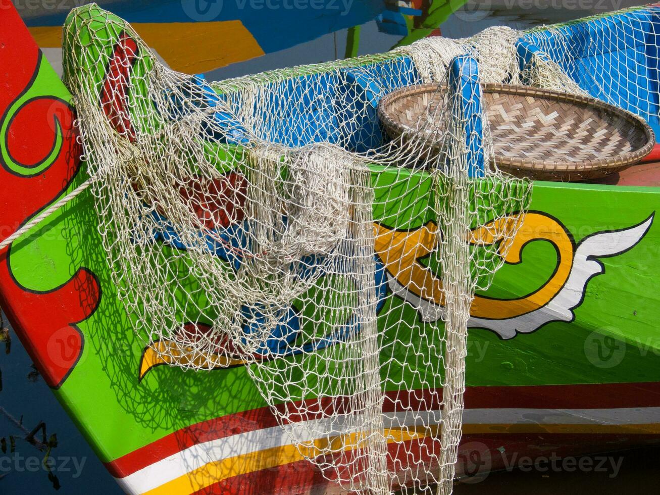 a colorful boat with a net photo
