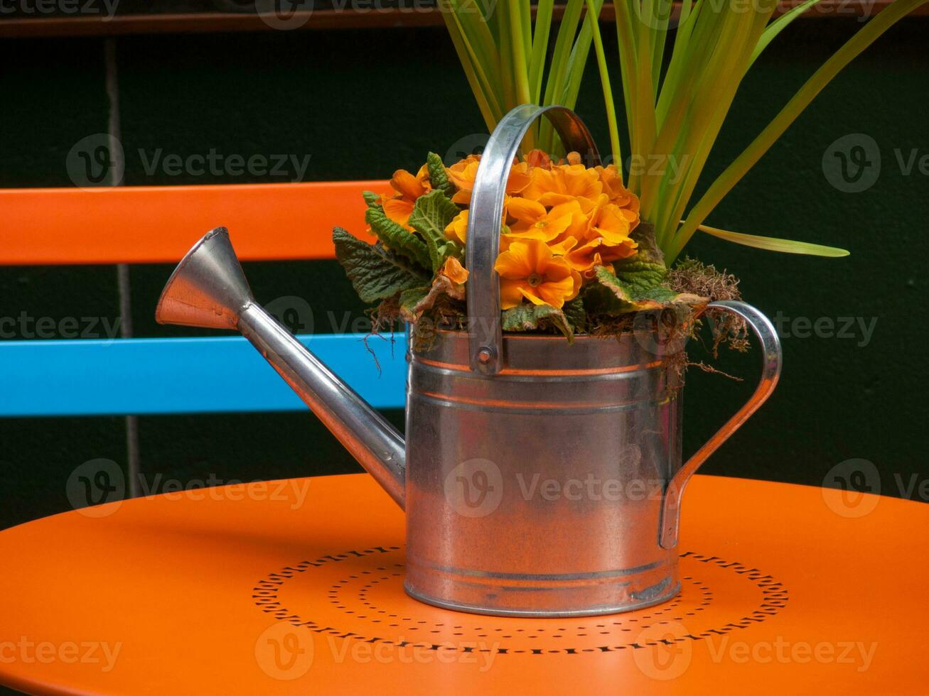 a watering can on a table photo