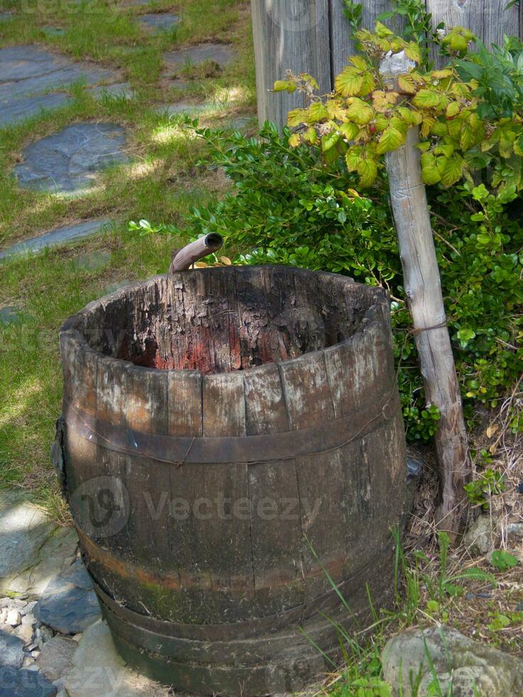 a wooden barrel sitting on the ground photo