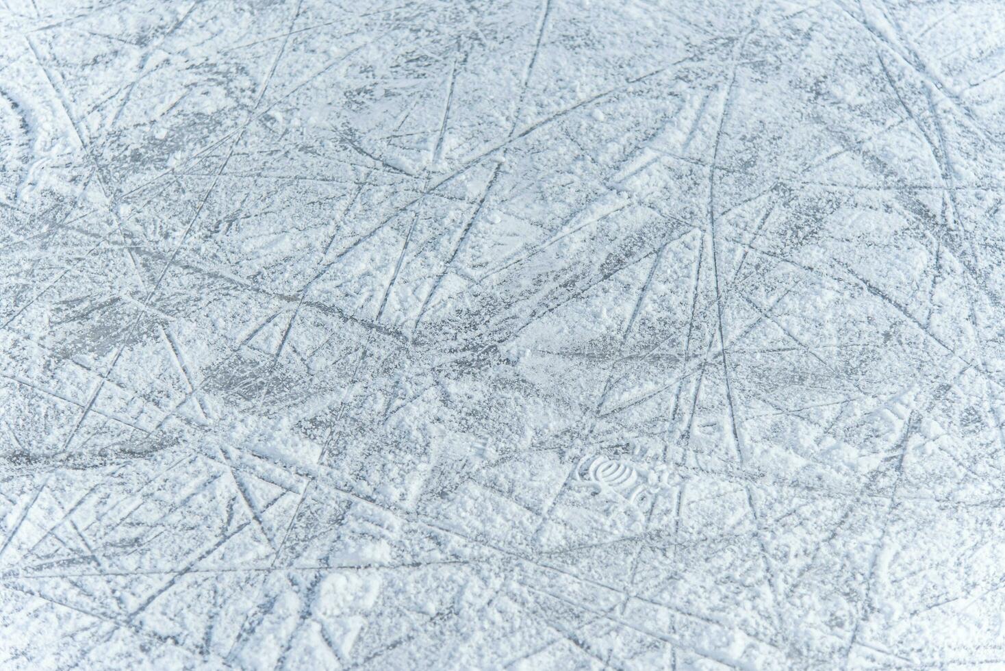 traces on the ice from skates on the rink photo