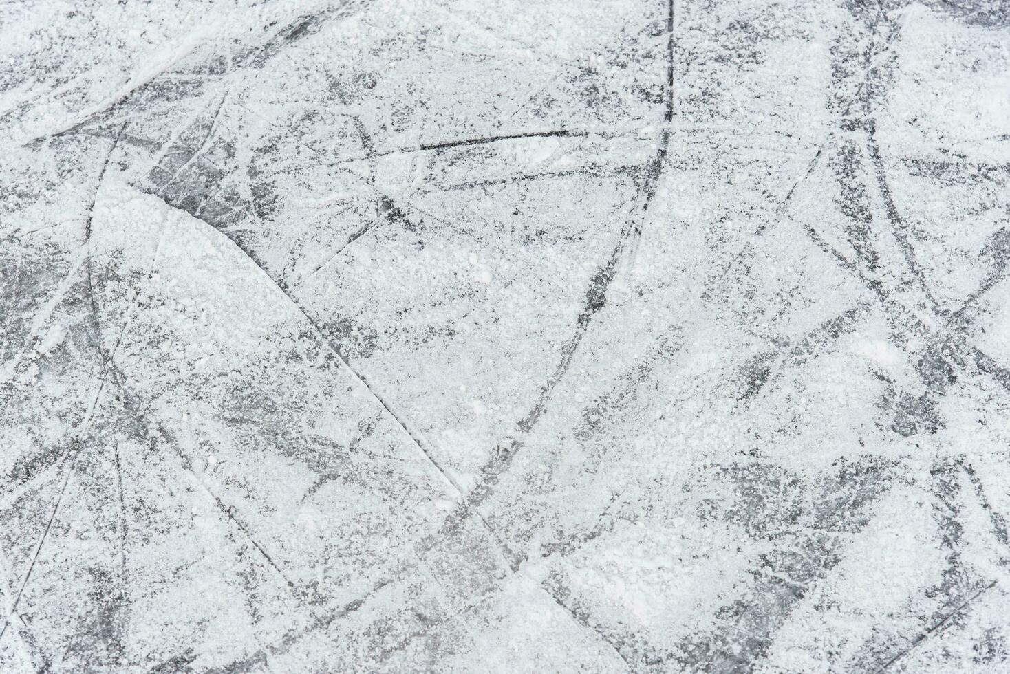 traces on the ice from skates on the rink photo