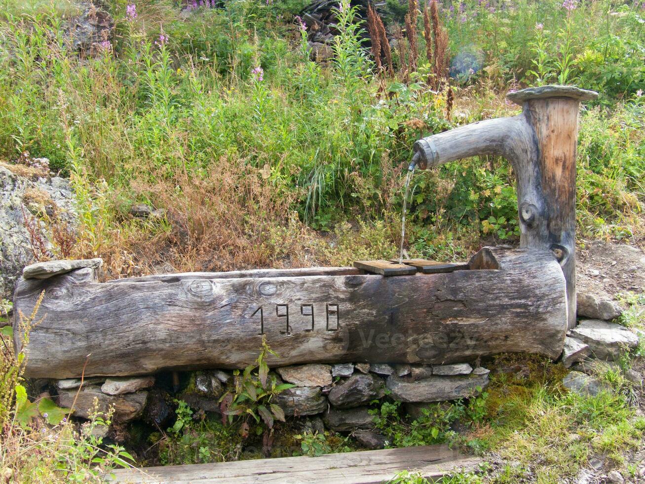 a wooden water fountain photo