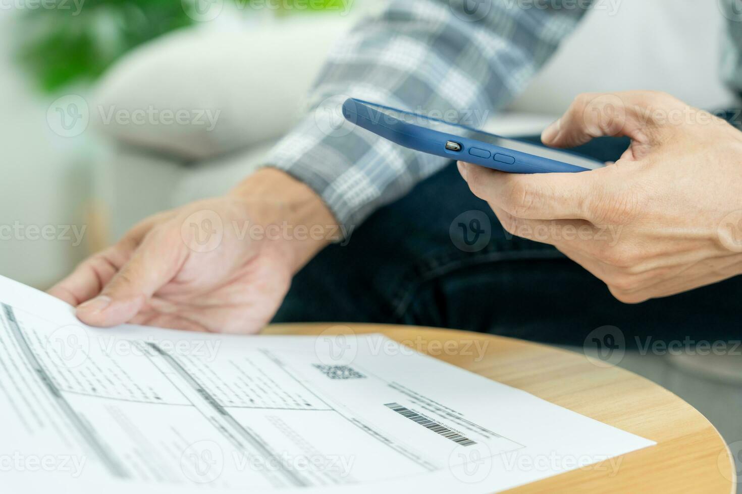 business man use phone to scan barcode or QR codes to pay credit card bill after receiving document invoice online. payment, receive, paying electricity, digital payments without money, technology photo