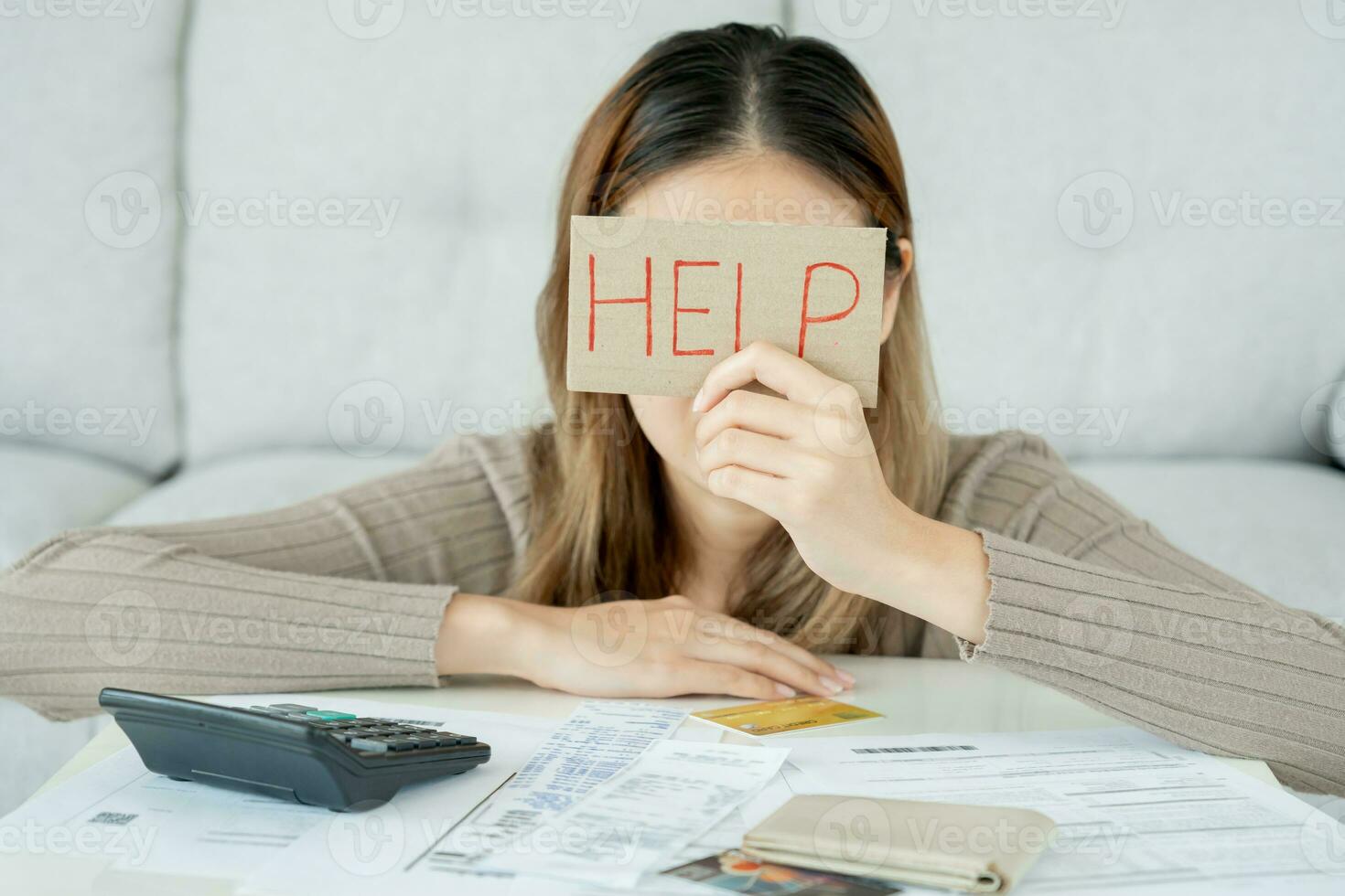 Stressed and headache asian woman with large bills or invoices no money to pay to expenses and credit card debt. shortage, Financial problems, mortgage, loan, bankruptcy, bankrupt, poor, empty wallet photo