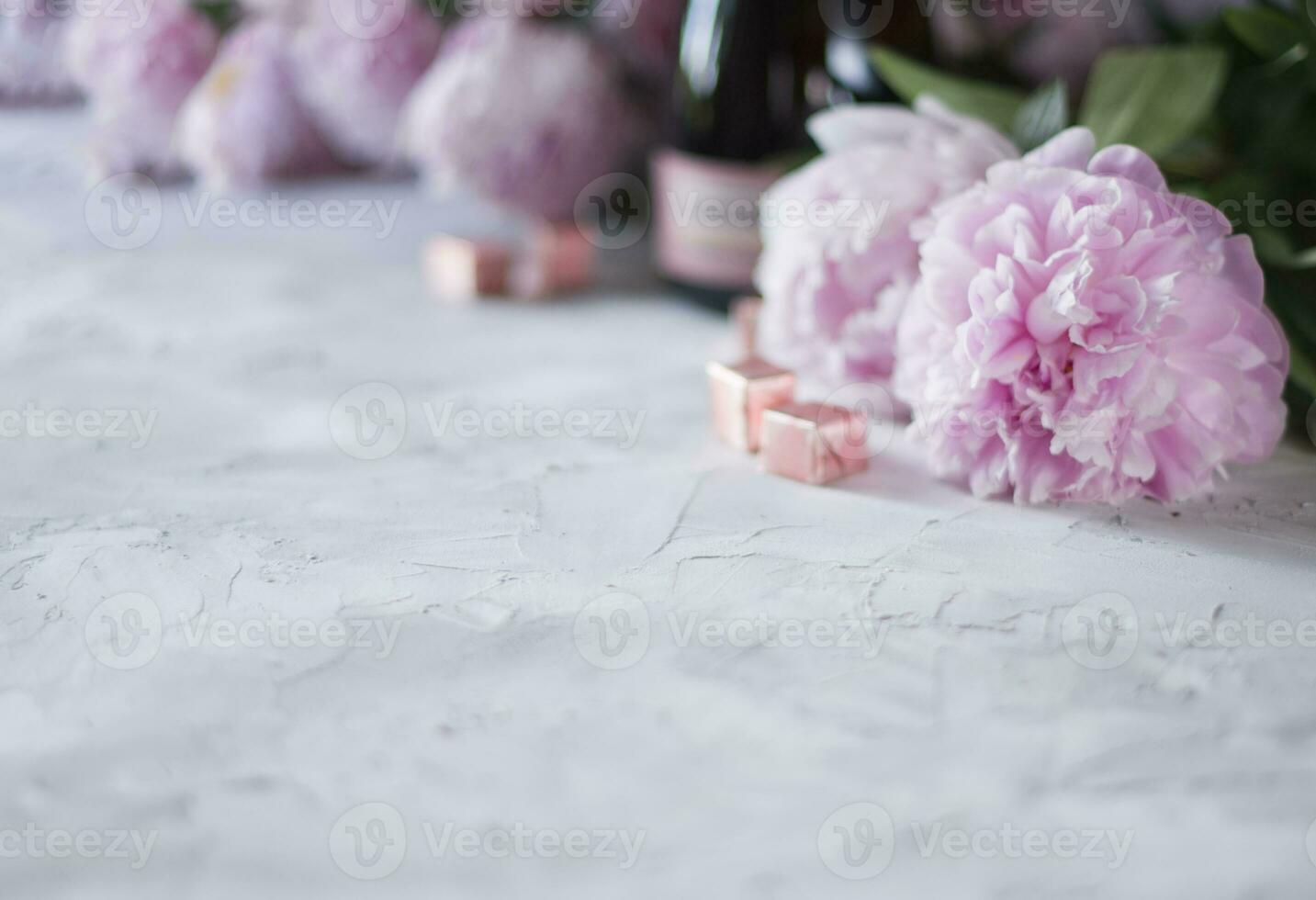 gray concrete background with selective focus,a bouquet of pink peonies,in blur photo