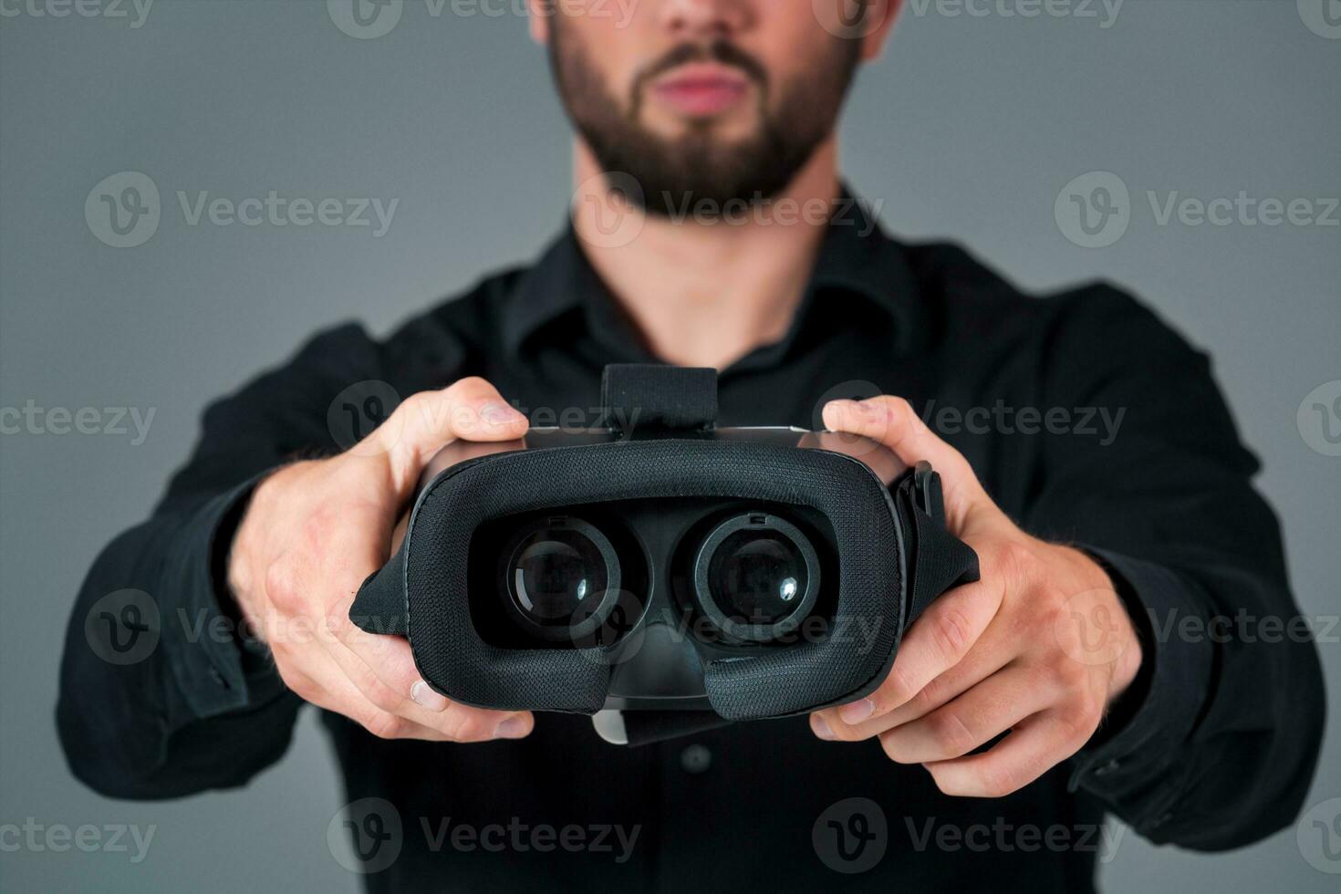 Man offers to wear glasses virtual reality, VR goggles, VR-headset glasses photo