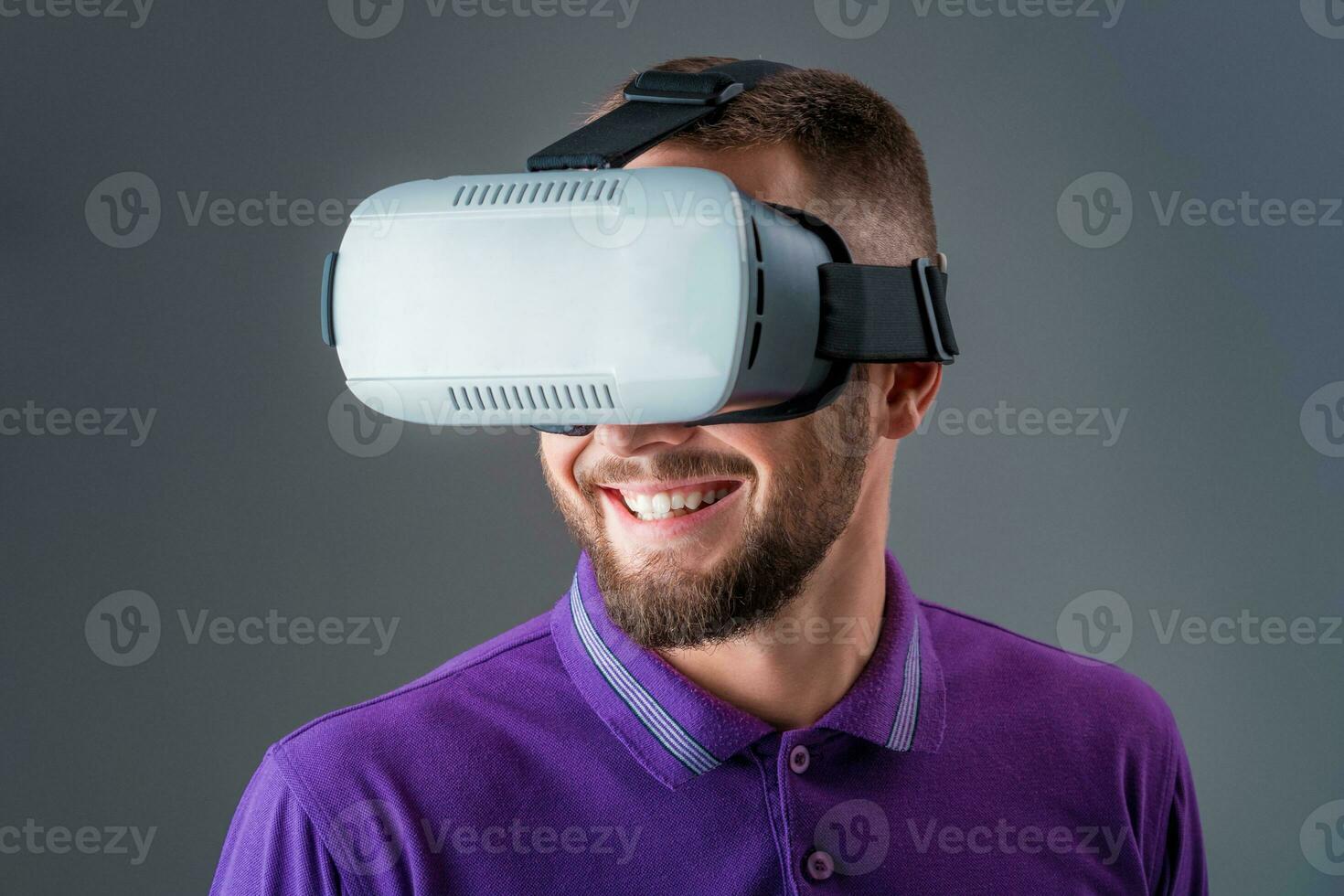 Man in studio wearing virtual reality headset playing game photo