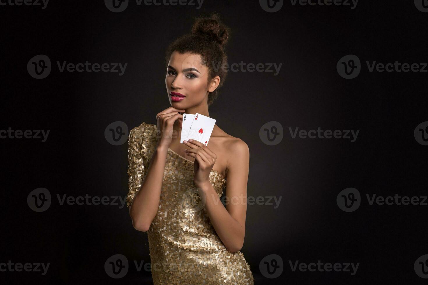 Pretty african girl shows two aces in casino poker and win photo