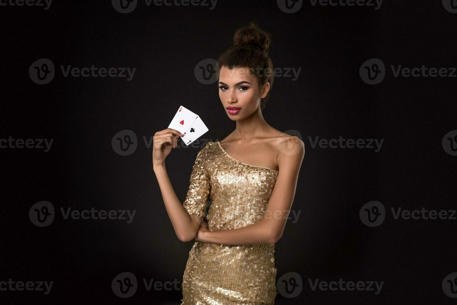 Pretty african girl shows two aces in casino poker and win photo