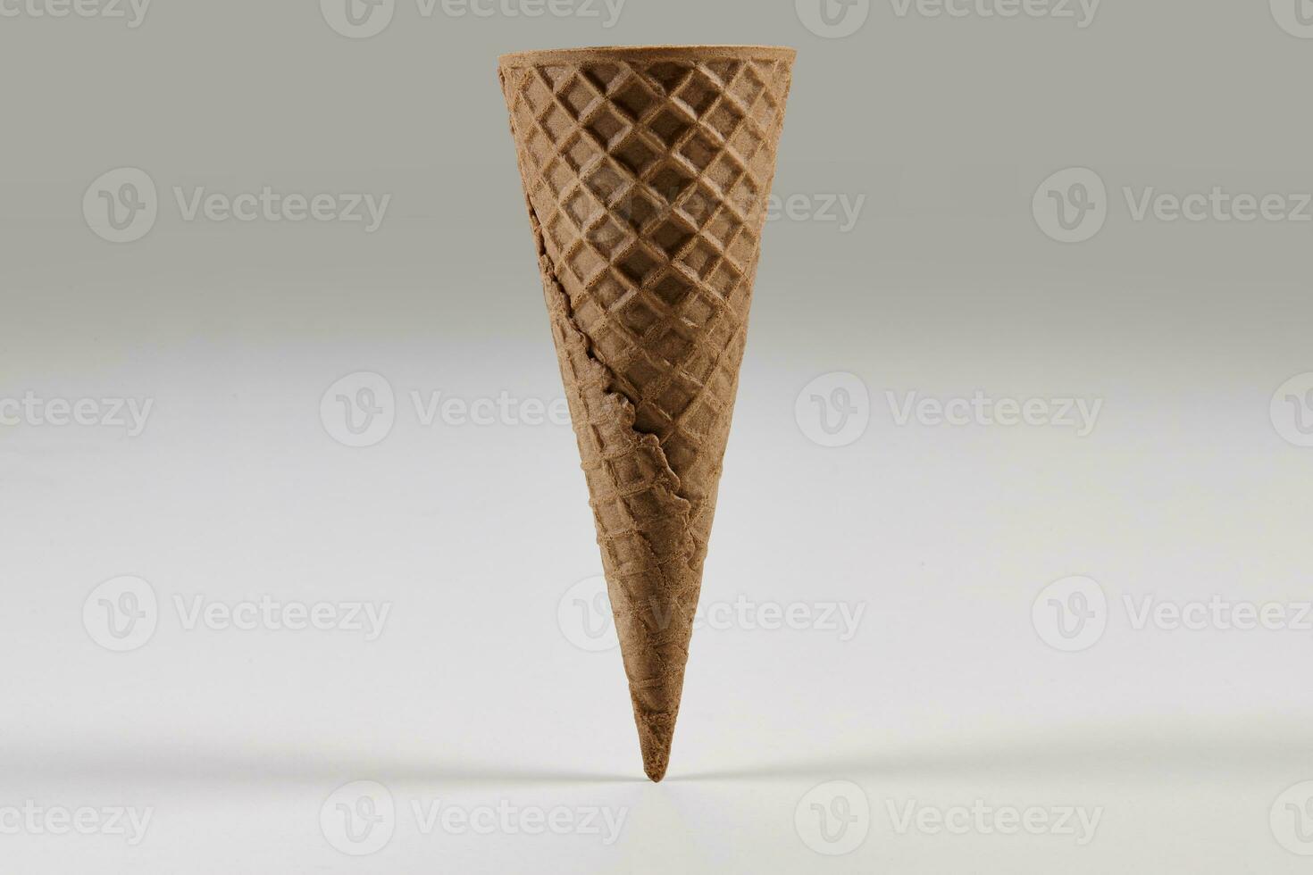 Empty, big, chocolate wafer cone for ice cream isolated on white. Concept of food, treats. Mockup, template for advertising and design. Close up photo